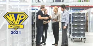 Woman holding tablet discussing business in warehouse